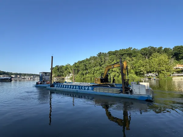 Work barge and excavator on the lake