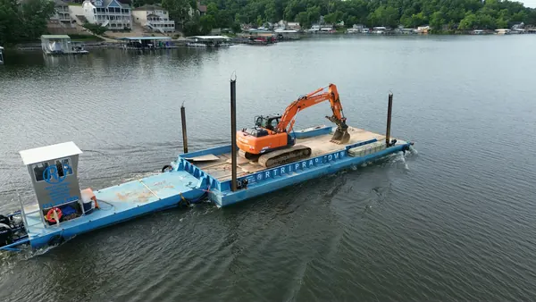 Barge-mounted excavator working a shoreline