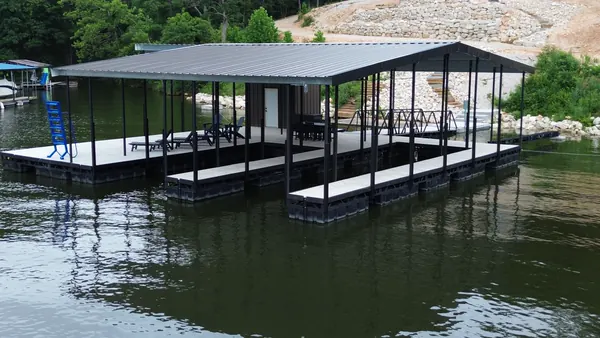 Large covered boat dock with white decking