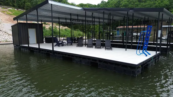 Covered dock with patio furniture and swim ladder