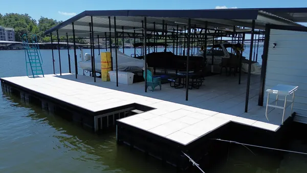 Covered dock alongside a lakefront home