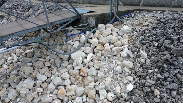 Placed boulders at the waterline beside a dock