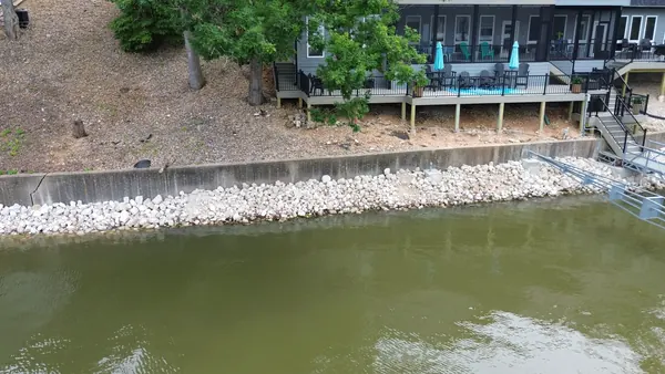 Concrete seawall with a rock toe at the waterline