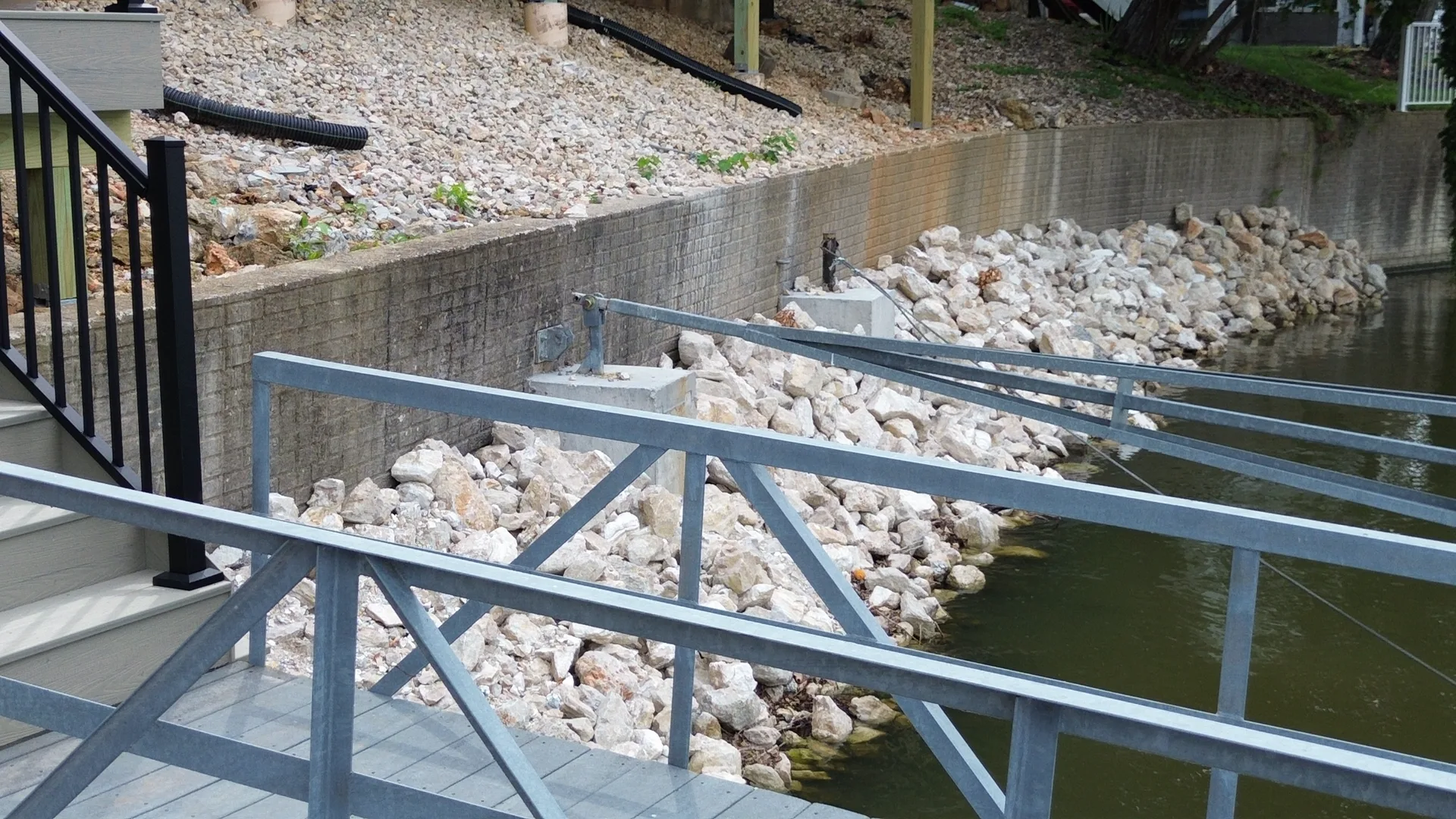 Rip rap reinforcing the base of a repaired seawall